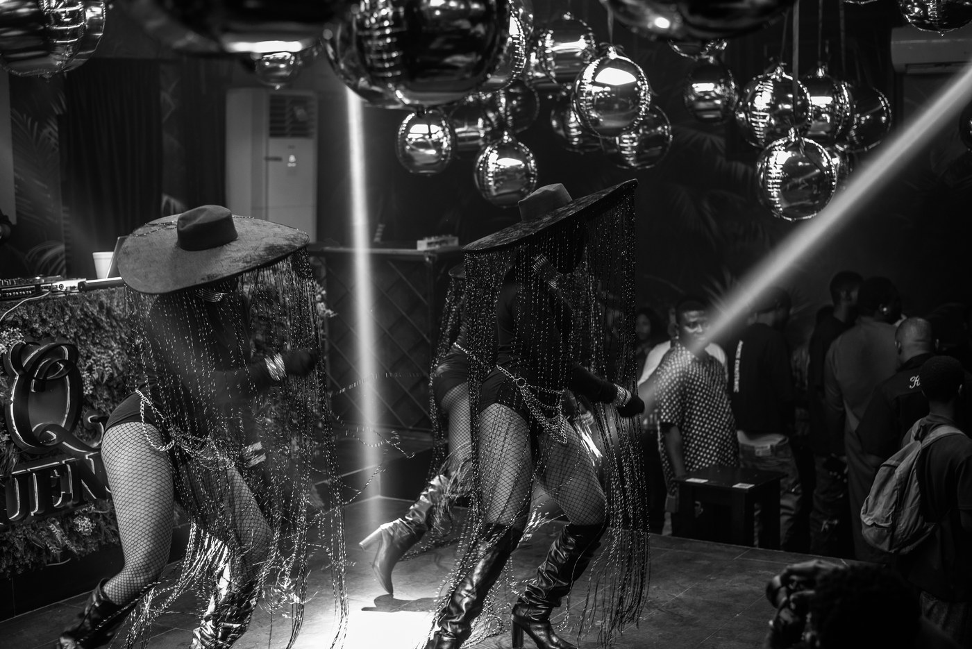 Dancers in fringe hats under the disco balls