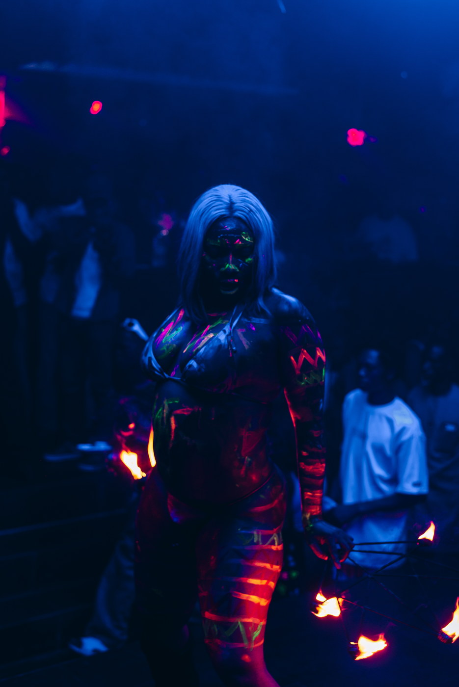 A body-paint performer with fire