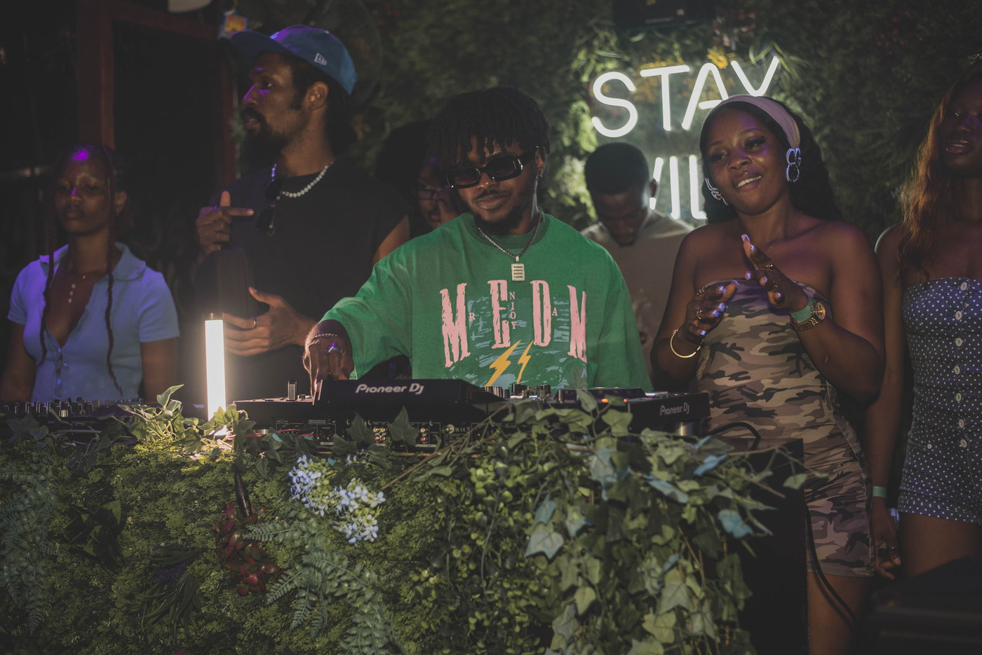 The DJ under the Stay Wild neon